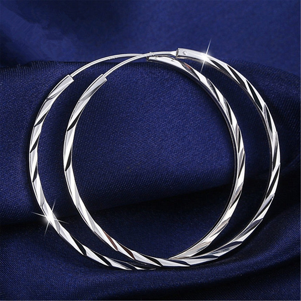 Exaggerated big ear hoop earrings with silver ornaments