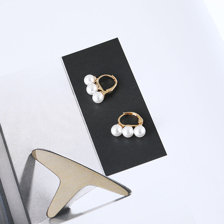 Three pearl earrings