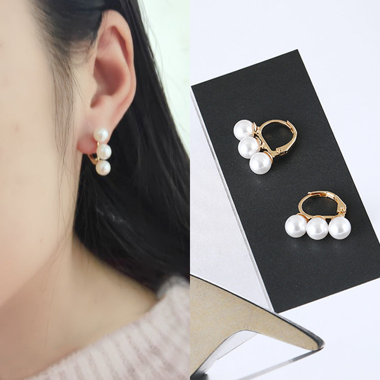 Three pearl earrings